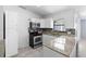 Updated kitchen with granite countertops, white cabinets, stainless steel appliances, and tile backsplash at 1842 W Cooper Dr, Deltona, FL 32725