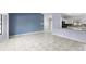 Open-concept living area with tiled floors, a partial view of the kitchen, and lots of natural light at 1842 W Cooper Dr, Deltona, FL 32725