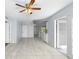 Open-concept living area with tile flooring, a ceiling fan, and doors leading to the exterior at 1842 W Cooper Dr, Deltona, FL 32725