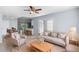 Bright living room with neutral furniture and a view of the kitchen and dining area at 1842 W Cooper Dr, Deltona, FL 32725