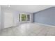 Bright living room with tiled floors, offering natural light and ample space for entertaining at 1842 W Cooper Dr, Deltona, FL 32725