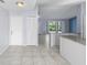 Living room with tiled floors with open access to kitchen and dining area at 1842 W Cooper Dr, Deltona, FL 32725