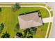 Aerial view of home showcasing roof, landscaping and proximity to neighborhood streets and sidewalks at 1860 Turnbull Lakes Dr, New Smyrna Beach, FL 32168