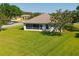 A manicured backyard, complete with a screened lanai, and lush lawn, providing a private outdoor oasis at 1860 Turnbull Lakes Dr, New Smyrna Beach, FL 32168