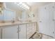 Bright bathroom with double sinks, ample counter space, and white cabinetry at 1860 Turnbull Lakes Dr, New Smyrna Beach, FL 32168