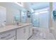 Bathroom featuring a white vanity, framed mirror, and a shower-tub combination at 1860 Turnbull Lakes Dr, New Smyrna Beach, FL 32168