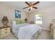 Inviting bedroom with a queen bed, neutral walls, and a window view of the outside greenery at 1860 Turnbull Lakes Dr, New Smyrna Beach, FL 32168