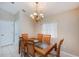 Traditional dining room featuring a wooden table with seating for six and elegant lighting at 1860 Turnbull Lakes Dr, New Smyrna Beach, FL 32168