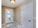 Welcoming entryway featuring neutral walls, tile flooring, and a decorative glass front door at 1860 Turnbull Lakes Dr, New Smyrna Beach, FL 32168