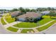 Well-kept single Gathering home on a corner lot with manicured green lawn, mature trees, and a two-car garage at 1860 Turnbull Lakes Dr, New Smyrna Beach, FL 32168