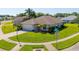A beautiful single-Gathering home features a well-manicured lawn and tropical landscaping at 1860 Turnbull Lakes Dr, New Smyrna Beach, FL 32168