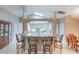 Bright, open kitchen with a breakfast bar, white cabinetry, and a seamless flow to the dining area at 1860 Turnbull Lakes Dr, New Smyrna Beach, FL 32168