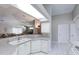 Open-concept kitchen seamlessly connects to the living area, featuring a breakfast bar and ample counter space at 1860 Turnbull Lakes Dr, New Smyrna Beach, FL 32168