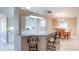 Kitchen with a breakfast bar, tiled floors, white cabinetry, and stainless steel appliances at 1860 Turnbull Lakes Dr, New Smyrna Beach, FL 32168