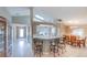 Open-concept kitchen with a breakfast bar, white cabinets, and modern appliances, flowing into dining at 1860 Turnbull Lakes Dr, New Smyrna Beach, FL 32168