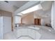 Kitchen with a breakfast bar, bright lighting, and white appliances at 1860 Turnbull Lakes Dr, New Smyrna Beach, FL 32168