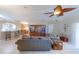 Spacious living room with tile floors and views to the dining and kitchen at 1860 Turnbull Lakes Dr, New Smyrna Beach, FL 32168