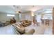 Spacious living room with vaulted ceilings, comfortable seating, and adjacent bar area at 1860 Turnbull Lakes Dr, New Smyrna Beach, FL 32168
