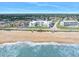 Aerial view of a sandy beach and the ocean alongside a condo complex at 1926 Ocean Shore Blvd # 3050, Ormond Beach, FL 32176
