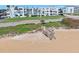 Sandy path to the beach alongside the condo with palm trees and green lawn at 1926 Ocean Shore Blvd # 3050, Ormond Beach, FL 32176