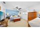 Spacious bedroom with a bright blue accent wall, ceiling fan, and ample natural light, creating a serene retreat at 1926 Ocean Shore Blvd # 3050, Ormond Beach, FL 32176