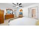 Comfortable bedroom featuring a ceiling fan, dresser, and ensuite bathroom, offering convenience and relaxation at 1926 Ocean Shore Blvd # 3050, Ormond Beach, FL 32176