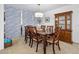 A formal dining room with a wood table and china cabinet underneath a modern light at 1926 Ocean Shore Blvd # 3050, Ormond Beach, FL 32176