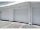 Garage parking spot in a multi-unit parking structure with white garage doors at 1926 Ocean Shore Blvd # 3050, Ormond Beach, FL 32176