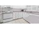 A kitchen featuring white cabinets, appliances, tile backsplash, and tile floors at 1926 Ocean Shore Blvd # 3050, Ormond Beach, FL 32176