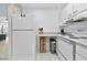 A bright kitchen with white appliances and drawers next to an open living space at 1926 Ocean Shore Blvd # 3050, Ormond Beach, FL 32176