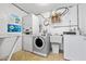 Functional laundry room with modern washer and dryer units, and utility sink at 1926 Ocean Shore Blvd # 3050, Ormond Beach, FL 32176