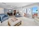 Bright living area with coastal decor, ceiling fan, and access to a private balcony overlooking the ocean at 1926 Ocean Shore Blvd # 3050, Ormond Beach, FL 32176
