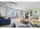 A cozy living room with comfortable furniture, a tv, and balcony ocean views at 1926 Ocean Shore Blvd # 3050, Ormond Beach, FL 32176