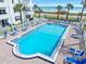 A rectangular pool is surrounded by lounge chairs with a white picket fence at 1926 Ocean Shore Blvd # 3050, Ormond Beach, FL 32176