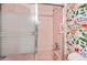 Pink tiled shower with glass doors and floral wallpaper on the adjacent wall at 1926 Ocean Shore Blvd # 3050, Ormond Beach, FL 32176