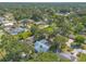 Overhead view of the home and neighborhood showing a large amount of mature trees and other homes at 1927 Orange Tree Dr, Edgewater, FL 32141