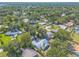 Property aerial highlights mature trees and landscaping; includes a metal roof and long driveway at 1927 Orange Tree Dr, Edgewater, FL 32141