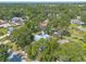 Aerial view of the property showcases its mature trees, landscaping, and neighborhood location at 1927 Orange Tree Dr, Edgewater, FL 32141