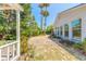 Spacious backyard featuring a large brick patio, mature trees, and a view of the home's exterior at 1927 Orange Tree Dr, Edgewater, FL 32141