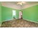 Bedroom with bright walls, ceiling fan, and doorway to the en-suite bathroom at 1927 Orange Tree Dr, Edgewater, FL 32141