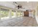 Large bonus room featuring a ceiling fan, tile flooring, and multiple windows at 1927 Orange Tree Dr, Edgewater, FL 32141