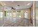 Spacious bonus room with a ceiling fan, tile flooring, and natural light at 1927 Orange Tree Dr, Edgewater, FL 32141