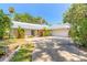 Attractive single-story home with a well-maintained lawn, a metal roof, and a two-car garage at 1927 Orange Tree Dr, Edgewater, FL 32141