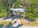 Charming single-story home featuring a metal roof, mature landscaping, and a spacious driveway at 1927 Orange Tree Dr, Edgewater, FL 32141