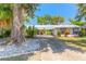 Inviting home with large tree, long driveway, well-maintained landscaping, and a durable metal roof at 1927 Orange Tree Dr, Edgewater, FL 32141