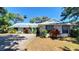 Charming single story home with a metal roof, mature landscaping, and a well maintained front yard at 1927 Orange Tree Dr, Edgewater, FL 32141