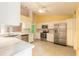 Bright kitchen with white cabinets, stainless steel appliances, marble counters, and ample counter space at 1927 Orange Tree Dr, Edgewater, FL 32141