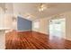 Bright living room featuring wood floors, a ceiling fan, and seamless flow into other living spaces at 1927 Orange Tree Dr, Edgewater, FL 32141