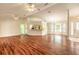 Open-concept living room boasts wood flooring, ceiling fans, and abundant natural light at 1927 Orange Tree Dr, Edgewater, FL 32141