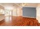 Inviting living room with wood floors, a ceiling fan, and an adjacent dining area at 1927 Orange Tree Dr, Edgewater, FL 32141
